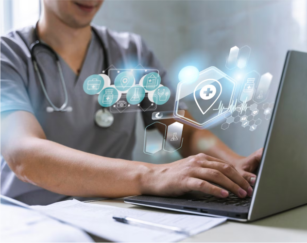 Healthcare professional using a laptop with holographic medical icons